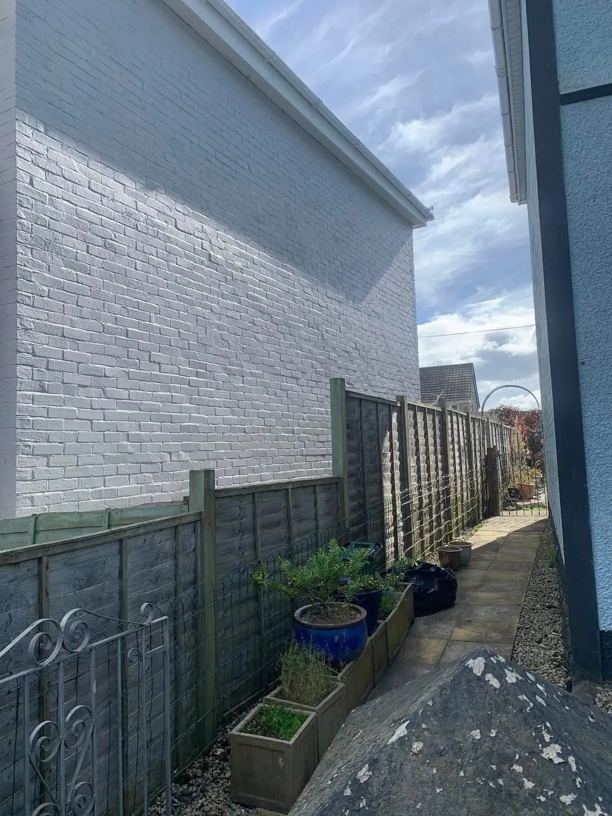 Freshly painted brick wall after preparation and masonry paint in Bovey Tracey